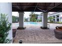 Community pool with lush landscaping providing a relaxing atmosphere and shaded seating areas at 2525 Maitland Crossing Way # 202, Orlando, FL 32810