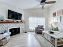 Living room showcasing the fireplace, white shiplap walls, wood look floors, and a cozy seating area at 260 Killarney Bay Ct # 6-6, Winter Park, FL 32789