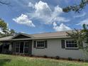 Exterior view of the single story home showcasing the neutral colors, updated windows and manicured landscaping at 2648 Amsden Rd, Winter Park, FL 32792