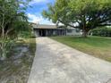 Well-kept home on large lot with mature trees and a long driveway that leads to the street at 2648 Amsden Rd, Winter Park, FL 32792