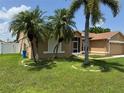 View of home showing front screened entry and side exterior details at 2693 Maxwell W Ct, Kissimmee, FL 34743