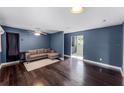 Inviting living room with a comfortable gray couch, a ceiling fan, and stylish hardwood flooring at 2915 Dean Ridge Rd, Orlando, FL 32825