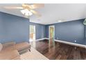Open living room with modern lighting, hardwood floors, and views into adjacent rooms enhancing spaciousness at 2915 Dean Ridge Rd, Orlando, FL 32825