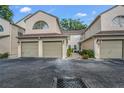 Exterior of a townhouse shows attached garages and well maintained landscaping at 3030 Clubview Dr # Ge, Orlando, FL 32822