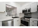 Bright kitchen with stainless steel appliances, ample cabinet space, and tiled backsplash at 3030 Clubview Dr # Ge, Orlando, FL 32822