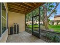 Screened patio features tile flooring, a wood ceiling, and a view of the grassy backyard at 3030 Clubview Dr # Ge, Orlando, FL 32822