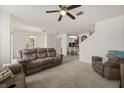 Spacious living room features neutral carpet, and an open layout to the dining and kitchen area at 3537 Seneca Club Loop # B, Orlando, FL 32808