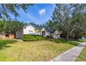 Well-maintained one-story home with manicured lawn, shrubbery and a two-car garage at 3954 Old Dunn Rd, Apopka, FL 32712