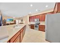 Spacious kitchen featuring stainless steel appliances, tiled flooring, and ample counter space at 3954 Old Dunn Rd, Apopka, FL 32712