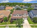 Expansive aerial view of the home showcasing the roof, manicured lawn, and the surrounding neighborhood at 4334 Tolkien St, Orlando, FL 32828