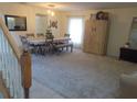 View of dining area from entryway, featuring modern decor, neutral colors, and a mix of tile and carpet at 4531 Se 30Th St, Ocala, FL 34480