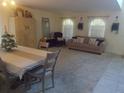 Open-concept living room featuring ample natural light, and tasteful decor, neutral carpet and tile at 4531 Se 30Th St, Ocala, FL 34480
