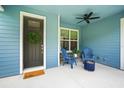 Cozy front porch with comfortable seating, a ceiling fan, and a welcoming entrance at 5531 Marys Villa Rd, Groveland, FL 34736