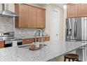 Modern kitchen features stainless steel appliances, granite countertops, and stylish tile backsplash at 5531 Marys Villa Rd, Groveland, FL 34736