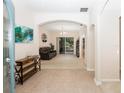 Open foyer with tile flooring, an arched entryway, and a view into the spacious living room at 636 Cheviot Ct, Apopka, FL 32712