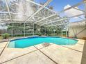 Inviting screened-in pool area with clear blue water, perfect for relaxation and outdoor entertainment at 6970 Knightswood Dr, Orlando, FL 32818