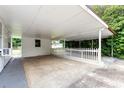 Spacious covered carport with a fenced-in area and ample parking space at 7102 Easter St, Winter Park, FL 32792