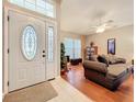 Inviting living room featuring neutral-toned walls, a ceiling fan, and tile entry leading to wood floors at 748 Andover Cir, Winter Springs, FL 32708