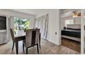Cozy dining area featuring wood-look floors and access to the bedroom at 7807 Pine Hawk Ln, Orlando, FL 32822
