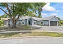 Charming single-story home featuring a gray brick driveway and a lush lawn at 8248 Marbella View Ct, Orlando, FL 32817