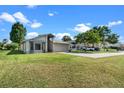 Single-story home featuring a well-manicured lawn and a two-car garage at 826 Long Bay Ct, Kissimmee, FL 34741