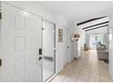 Bright foyer with tile flooring, white walls, and view into the living room at 8308 Granada Blvd, Orlando, FL 32836