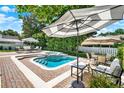Inviting backyard swimming pool with lounge furniture and lush landscaping, perfect for outdoor entertaining at 991 Hawthorne Cove Ct, Ocoee, FL 34761