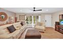 Comfortable living room showcasing modern decor, including a plush sofa, brick accent wall, and wood flooring at 1000 Sal St, Ocoee, FL 34761