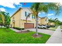 Two-story home with an attached two-car garage, well-maintained lawn, and attractive landscaping elements at 10070 Red Eagle Dr, Orlando, FL 32825