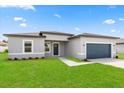 Beautifully landscaped front yard leading to a modern home with a two-car garage at 14905 Sw 39Th Cir, Ocala, FL 34473