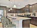 Spacious kitchen featuring a large island with seating, granite countertops, and stainless steel appliances at 1606 Lima Ave, Kissimmee, FL 34747
