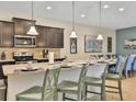Open-concept kitchen with granite countertops, a breakfast bar, and views of the dining area at 1606 Lima Ave, Kissimmee, FL 34747