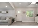 Bright living room featuring a white front door and luxury vinyl plank flooring at 1615 W Gadsen Blvd, Orlando, FL 32812