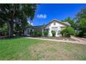 Charming one-story home with lush green lawn, mature trees, and shrubbery at 1621 Sunnyside Dr, Maitland, FL 32751