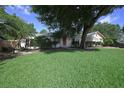 Charming one-story home with lush green lawn and mature trees providing shade and curb appeal at 1621 Sunnyside Dr, Maitland, FL 32751