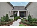 Inviting front entrance with lush landscaping, walkway, and decorative front door at 1653 Cheyenne Trl, Maitland, FL 32751