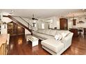 Open-concept living room with hardwood floors, large sectional sofa, and kitchen view at 1653 Cheyenne Trl, Maitland, FL 32751