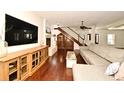 Spacious living room featuring hardwood floors, a fireplace, and stairs with custom wine storage at 1653 Cheyenne Trl, Maitland, FL 32751