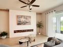 Cozy living room with decorative wall accents, stylish furniture, and a sliding glass door to the outside at 17319 Million Lakes Ct, Clermont, FL 34714