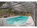 A screened-in pool with lounge chairs under a sunny sky, offers a relaxing outdoor space at 203 N Sweetwater Blvd, Longwood, FL 32779