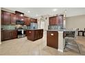 Spacious kitchen featuring dark wood cabinets, stainless steel appliances, tile backsplash, and two kitchen islands at 2319 Dammar St, Orlando, FL 32824