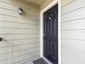 Close-up of the black front door with house number 5201 and an outdoor light fixture at 2550 N Alafaya Trl # 9201, Orlando, FL 32826