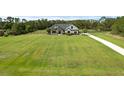Expansive front yard view of modern farmhouse, showcasing the property's spaciousness and curb appeal at 27071 Moss View Dr, Tavares, FL 32778