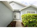 Close-up of house front door, walkway, and manicured landscaping at 302 Cello Cir, Winter Springs, FL 32708