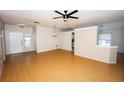Open-concept living room featuring gleaming hardwood floors and natural light at 302 Cello Cir, Winter Springs, FL 32708