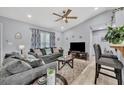 Cozy living room features modern furnishings, large windows, and an open floor plan at 3043 Mapleshade St, Deltona, FL 32738