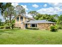 Charming two-story home with stone accents, beautiful landscaping, and a well-maintained lawn at 3102 Cecelia Dr, Apopka, FL 32703