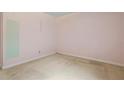 Simple bedroom with neutral carpet, light pink walls and minimal fixtures at 3223 N Orange Ave, Orlando, FL 32803