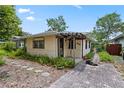 Charming home with a paved walkway, covered entry, and lush landscaping at 3223 N Orange Ave, Orlando, FL 32803