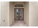 Elegant double front doors with glass panes and brick entryway at 343 Leslie Ln, Lake Mary, FL 32746